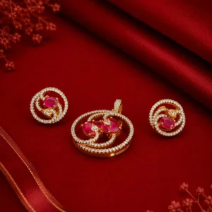 Gold-tone pink stone jewelry set with sparkling crystal detailing, including matching earrings and pendant.