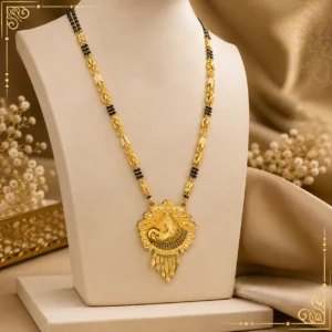 "Traditional gold-tone black beaded mangalsutra with intricate designer pendant displayed on a jewellery bust"