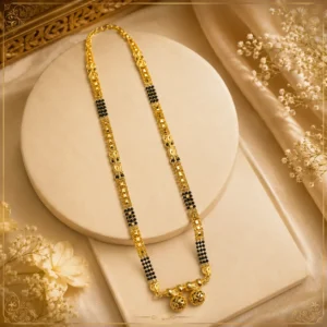 "Traditional gold-tone black beaded mangalsutra with intricate designer pendant displayed on a cream jewellery stand"
